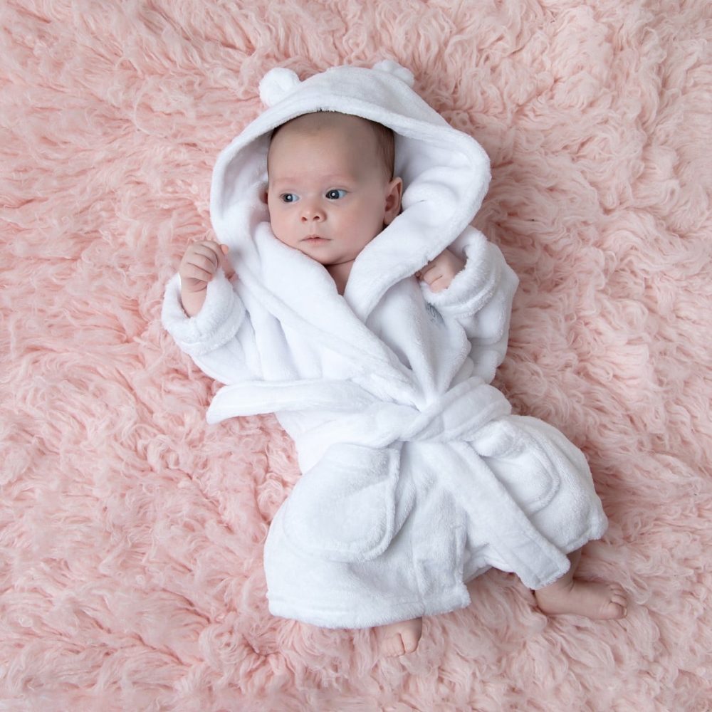 Baby with a cuddly white dressing gown from Teddypost