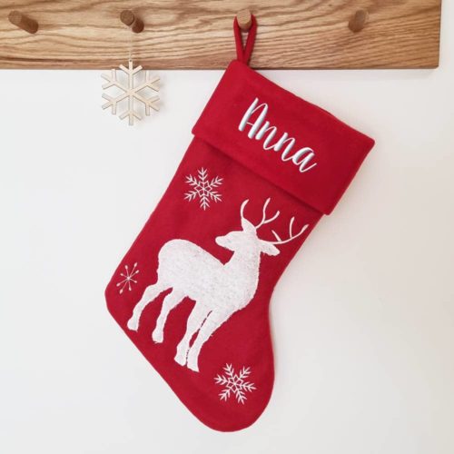 Red Christmas stocking with white reindeer