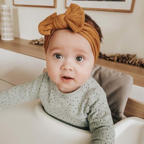 Baby with mustard colored headband