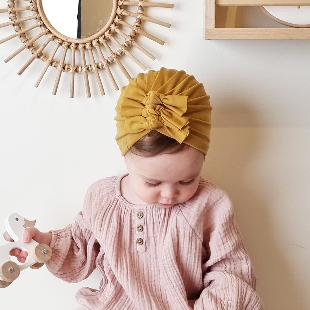 Baby with mustard colored turban